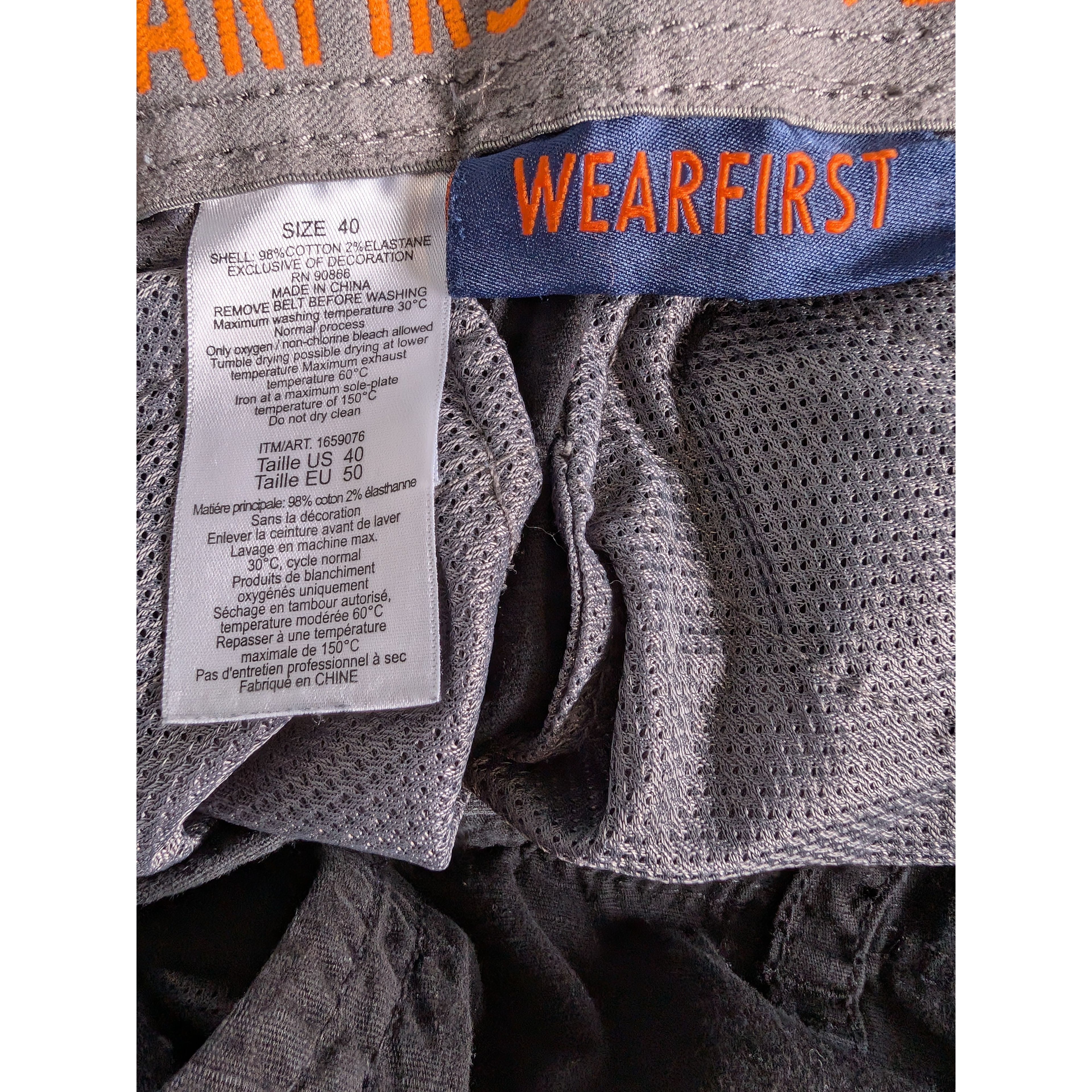 Gray textured fabric with a 'WEARFIRST' tag and size label.