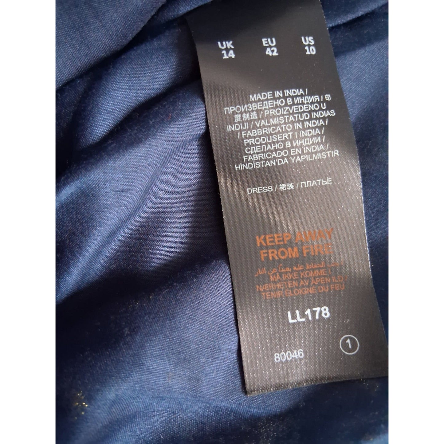 Clothing label on a blue fabric background