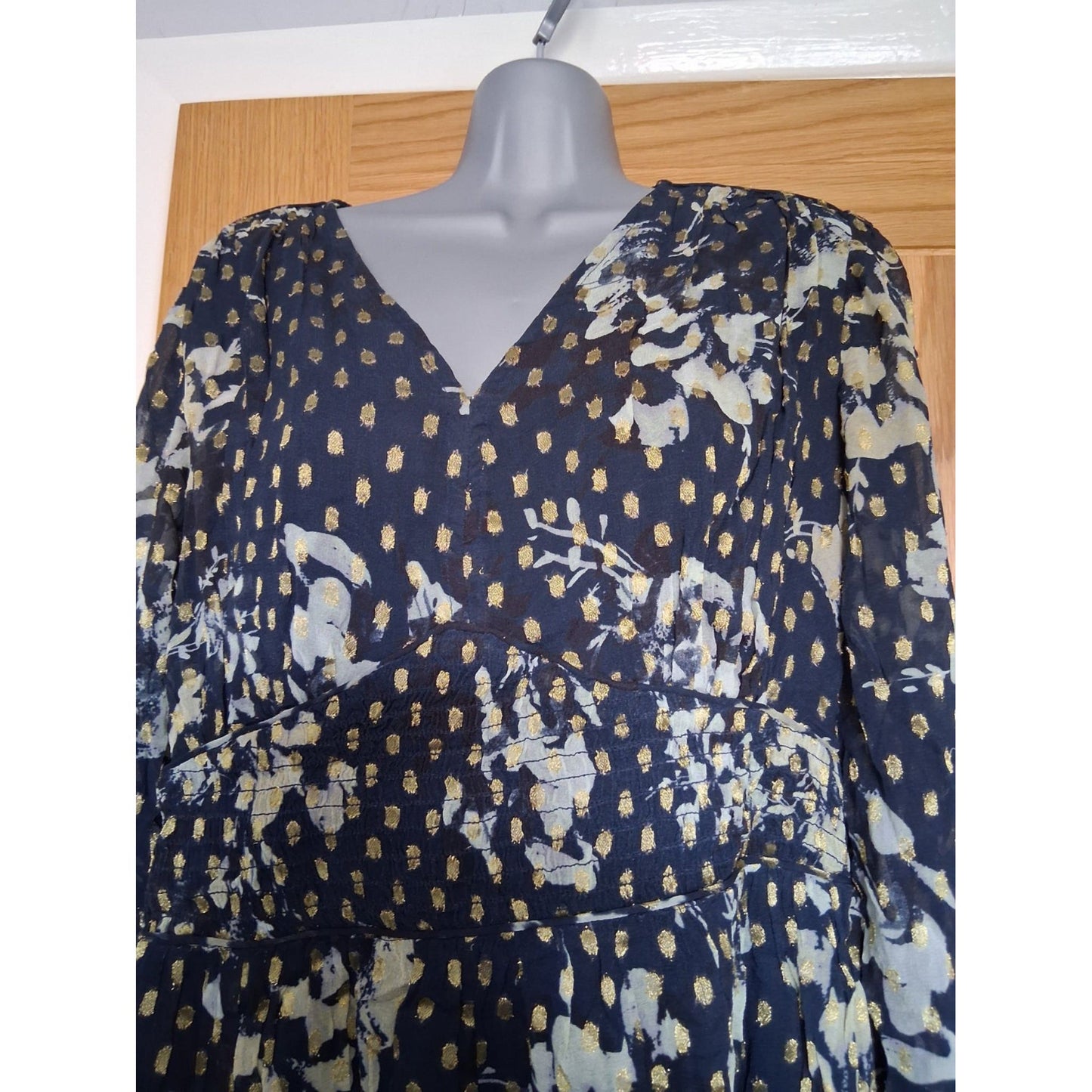 Navy blue fabric with white floral pattern on a mannequin