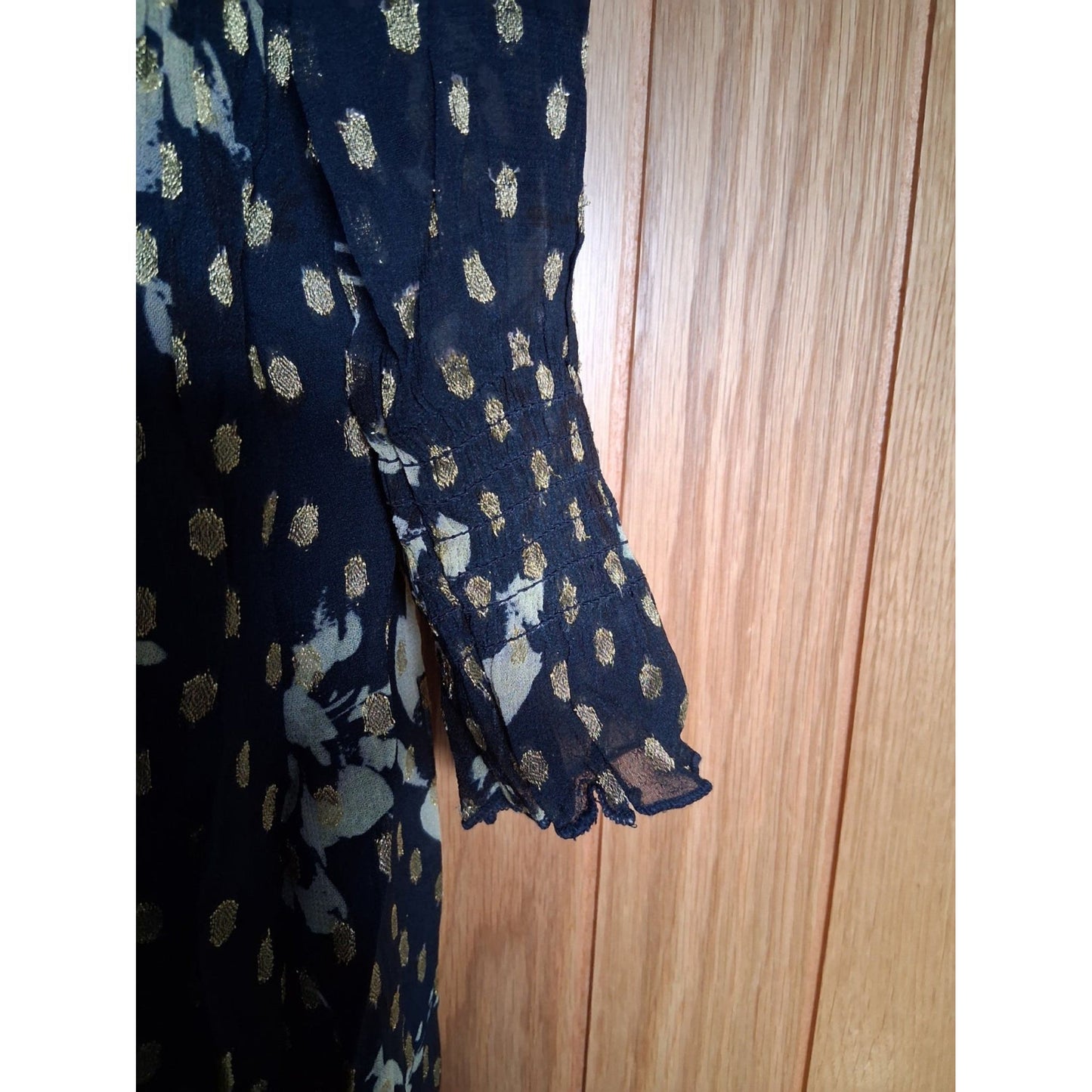 Folded fabric with gold and white patterns