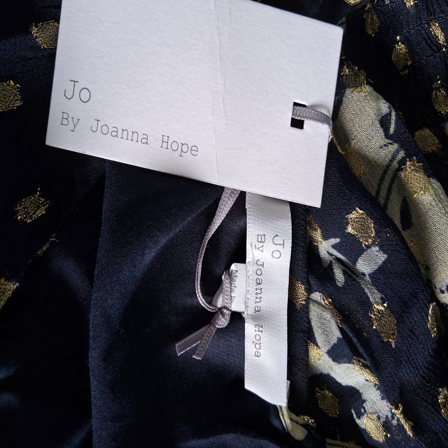 Navy fabric with gold and white patterns and JO by Joanna Hope labels.