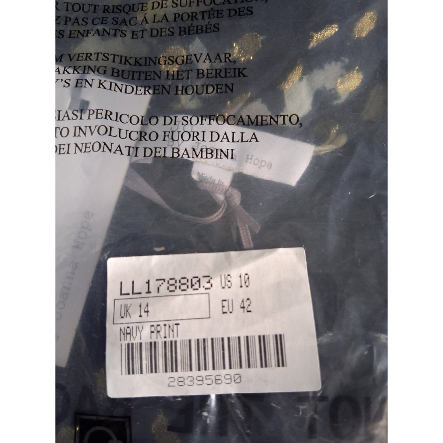 Close-up of a label with text and a barcode on a dark background
