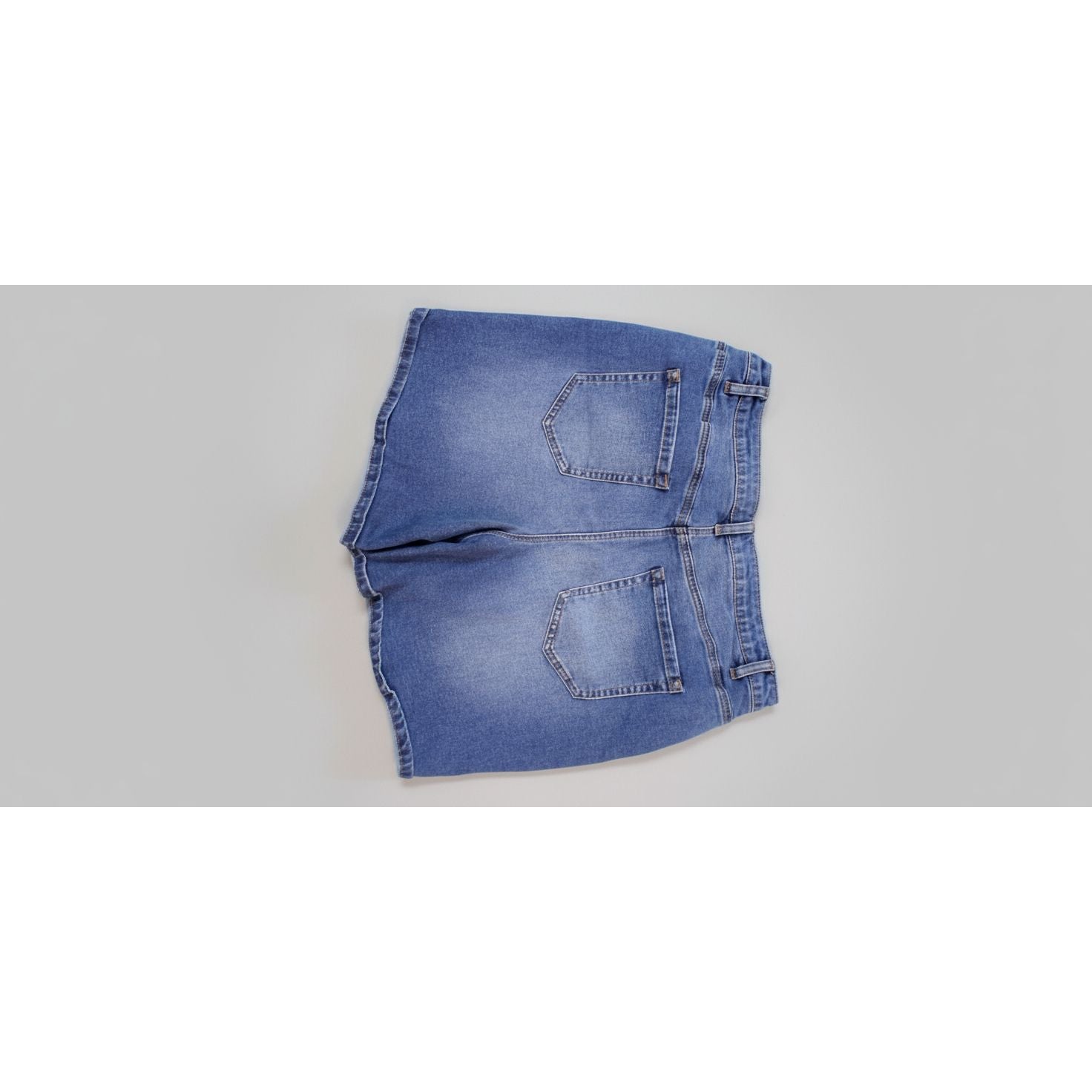 Blue denim shorts on a textured surface