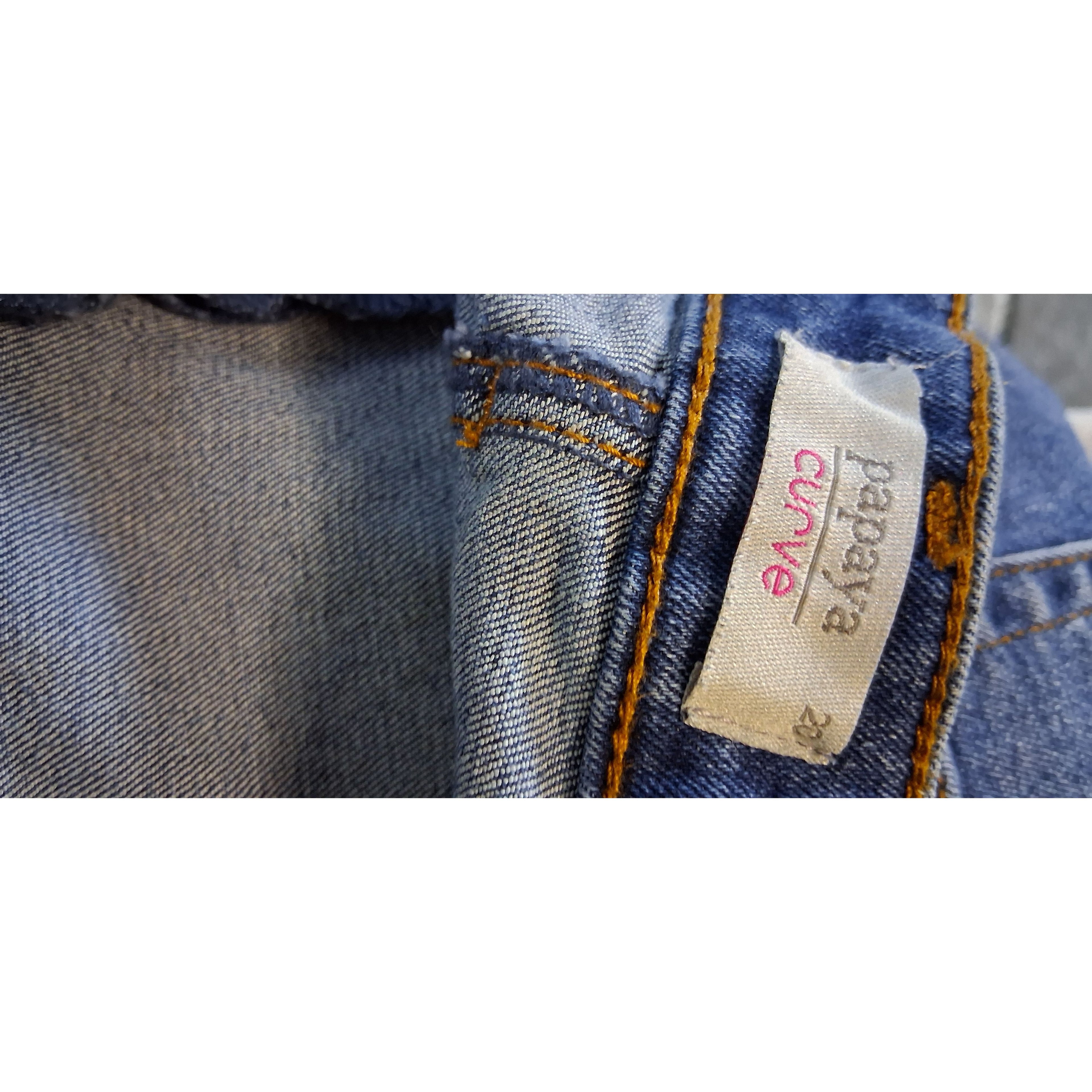 Close-up of a 'Papaya' brand label on blue denim fabric.