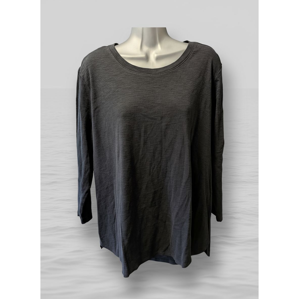 Mannequin wearing a gray long-sleeve shirt in a kitchen setting