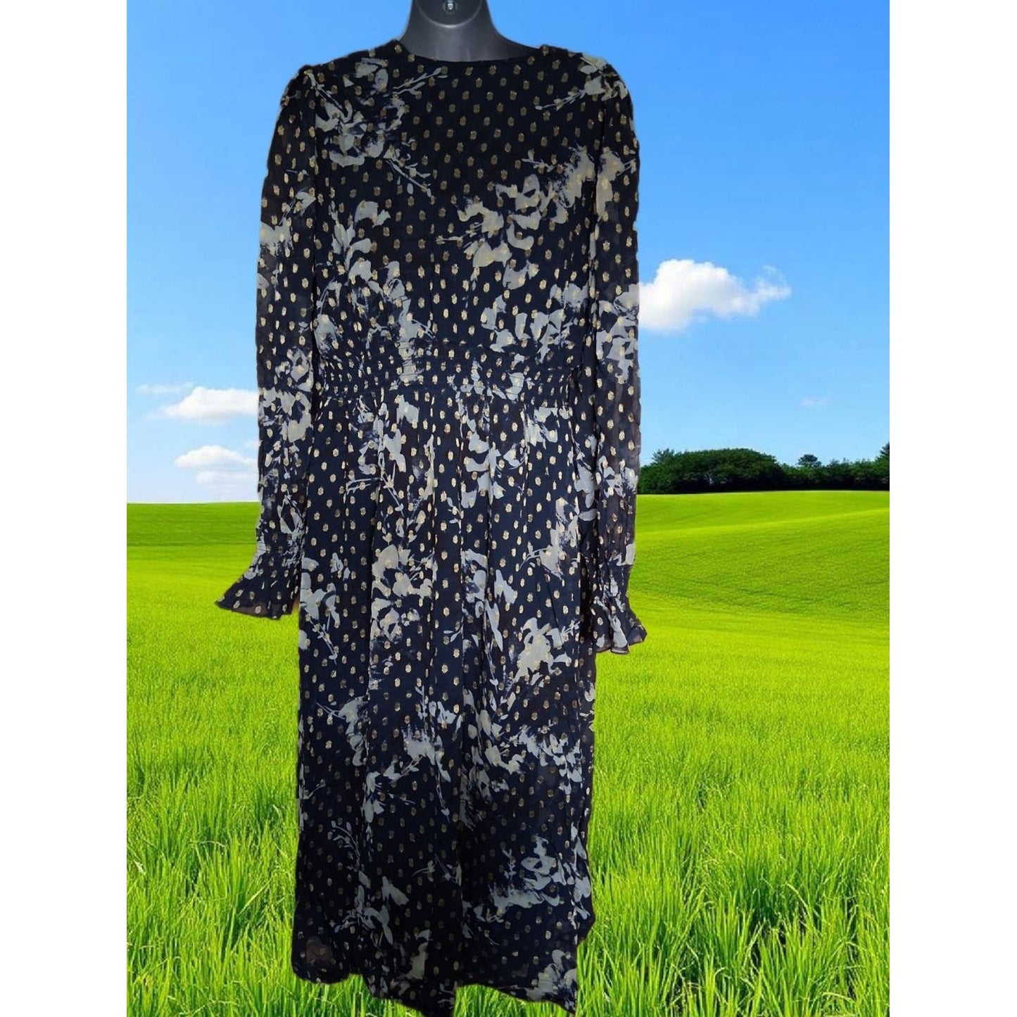 Navy floral dress on a mannequin against a green field and blue sky background