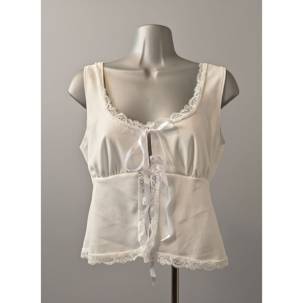 White lace-trimmed top on a mannequin in a store setting