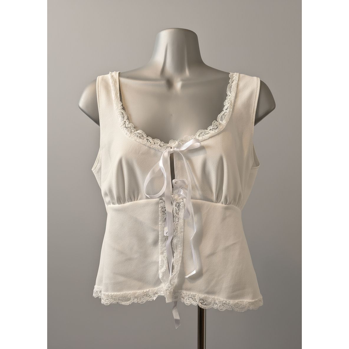 White lace-trimmed top on a mannequin in a store setting