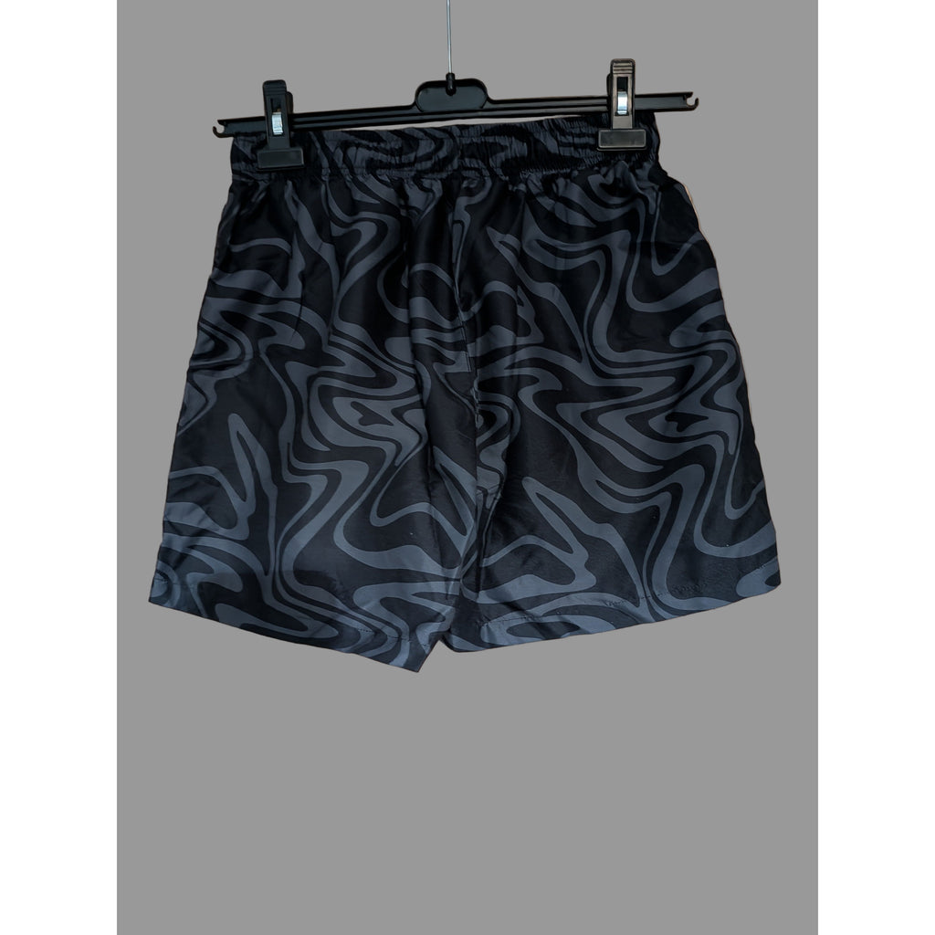 Black patterned shorts on a hanger 