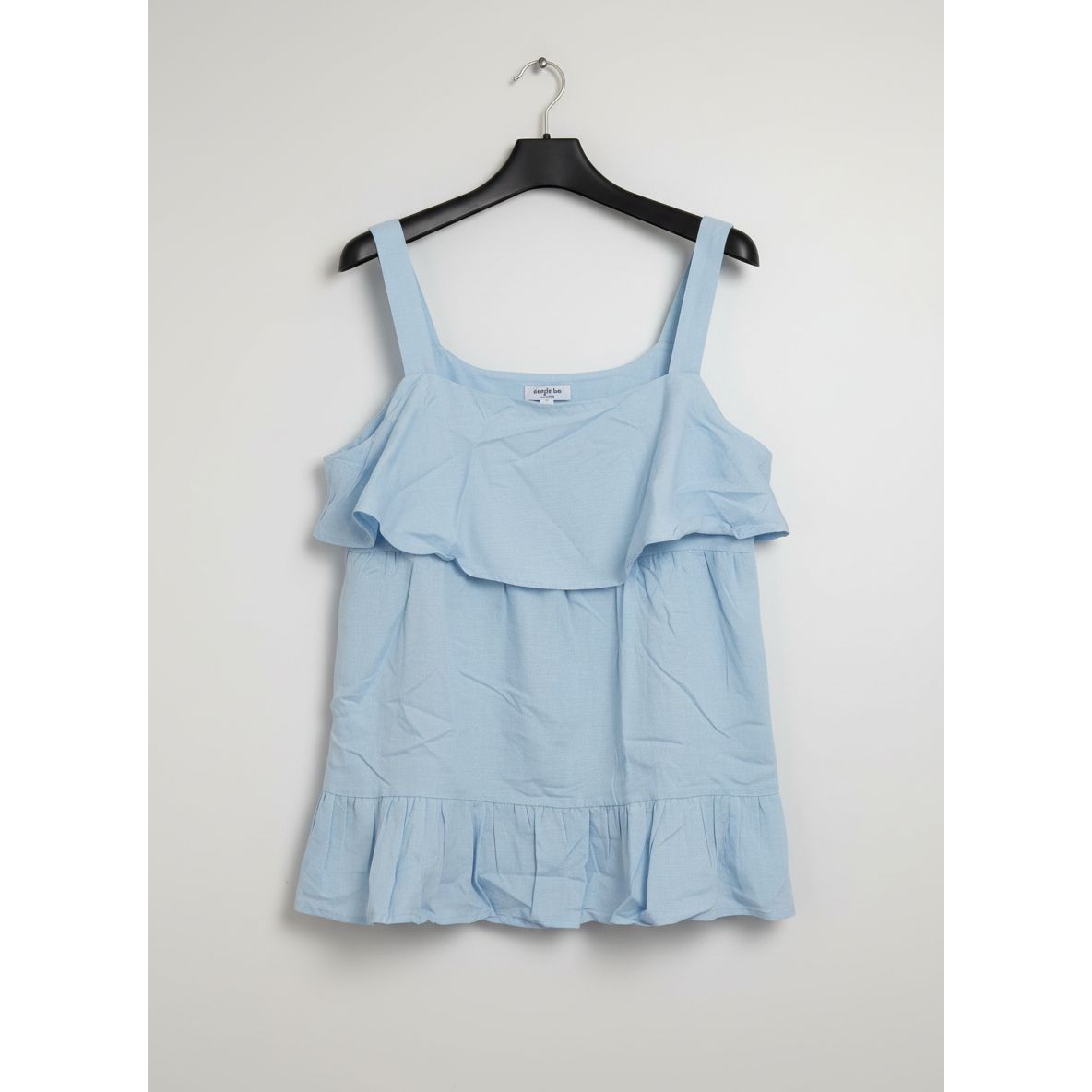 Light blue top on a hanger 