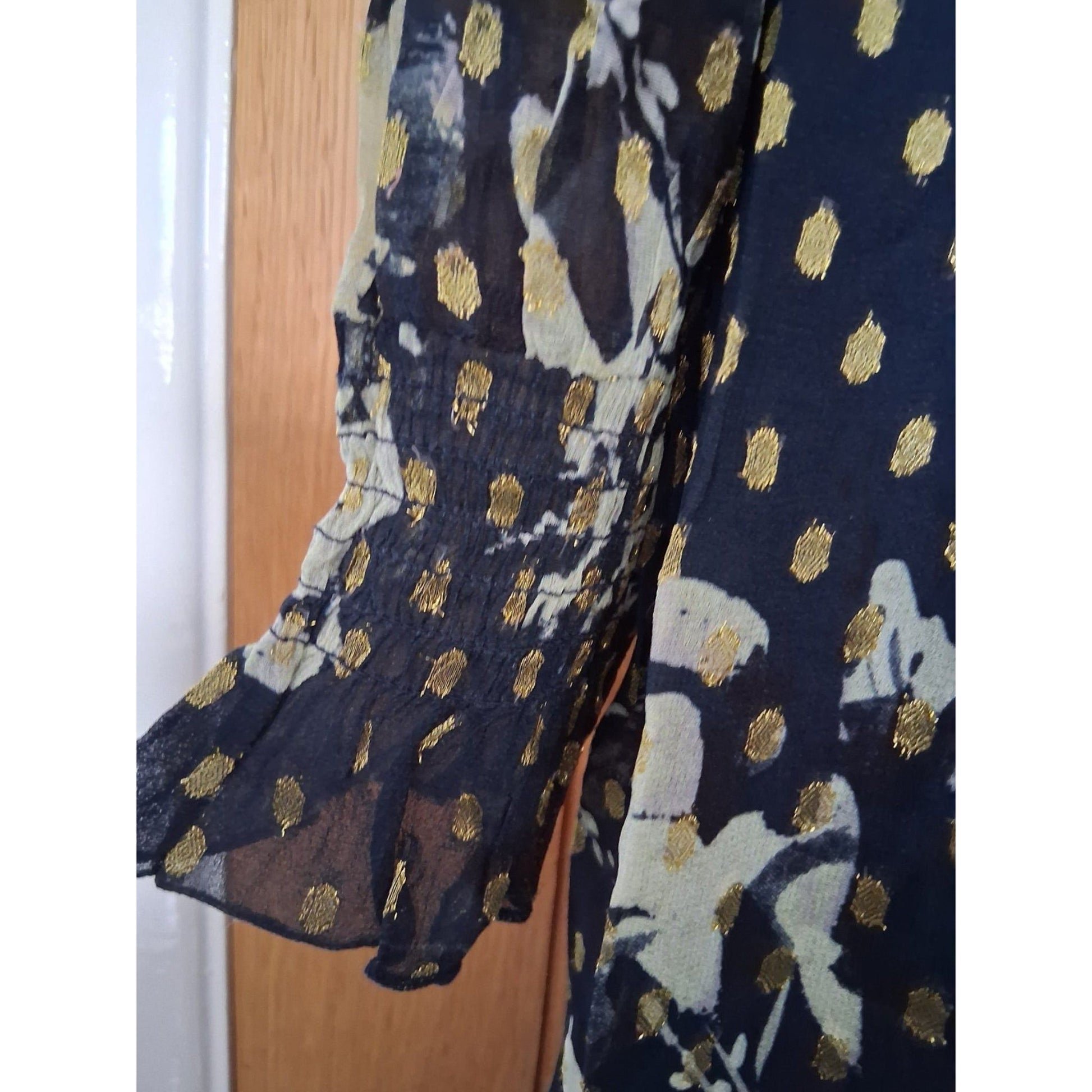 Navy fabric with gold polka dots and floral patterns 