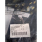 Close-up of a label with text and a barcode on a dark background