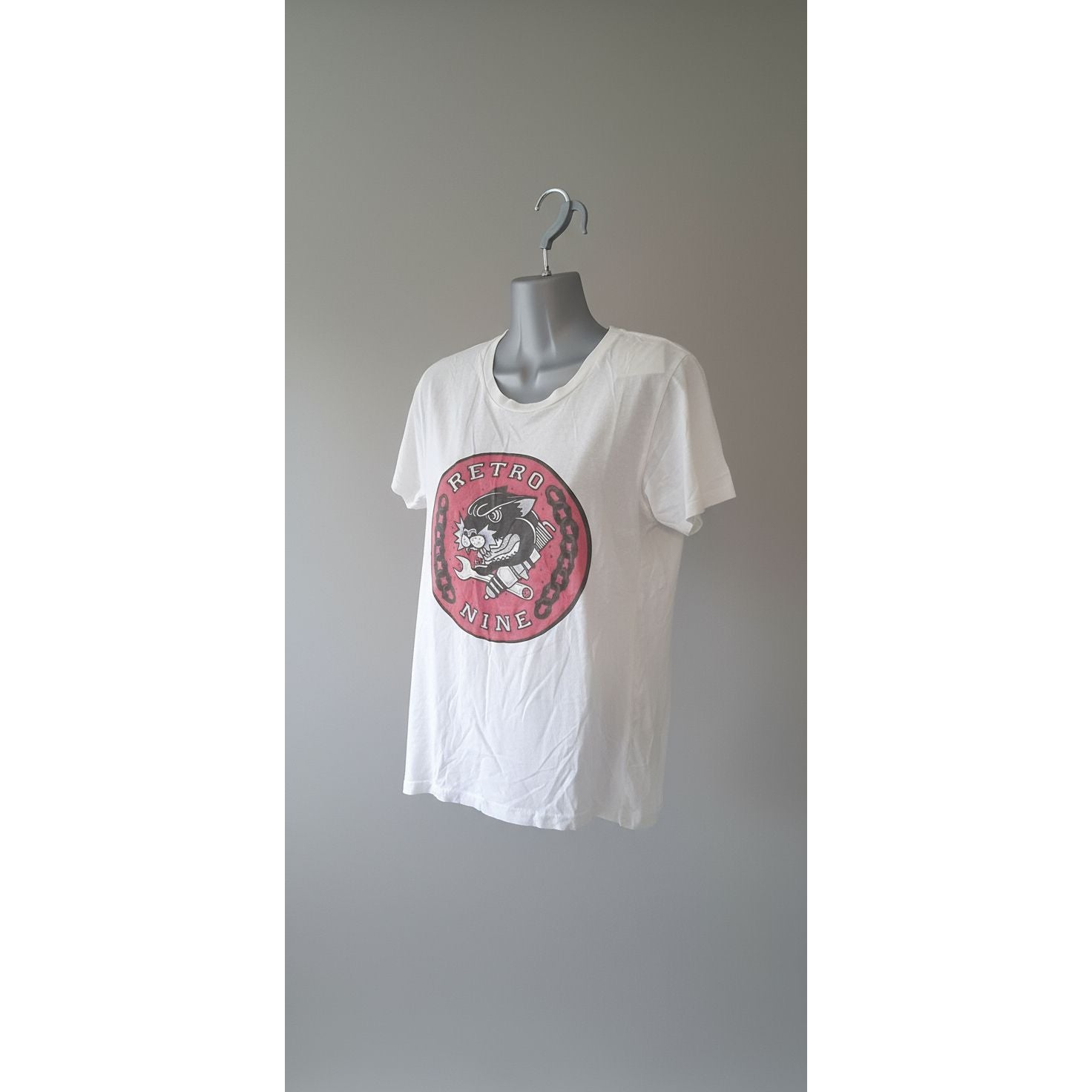 White tank top with a red logo on a tiled floor