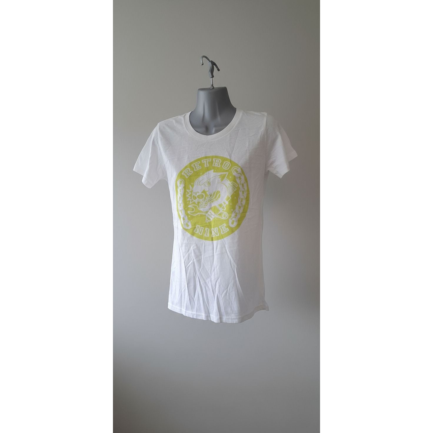 White t-shirt with a yellow logo on a gray door