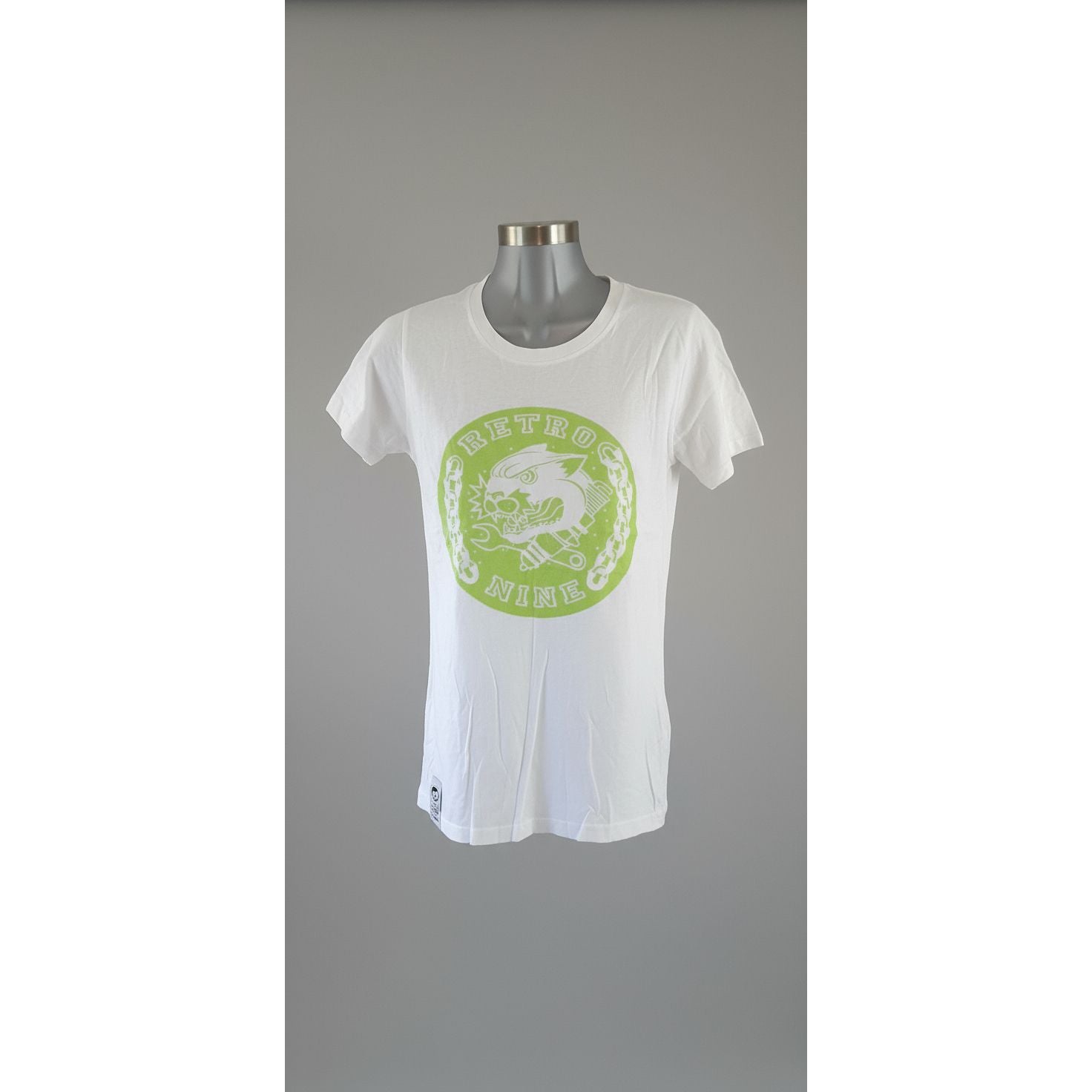 White t-shirt with a green logo on a mannequin against a tiled wall.