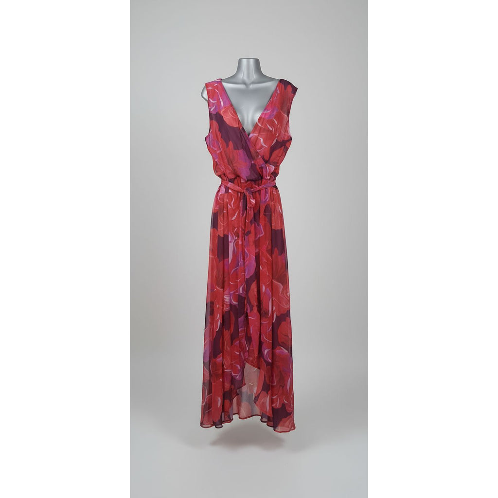 Red patterned dress on a mannequin against a geometric-patterned wall.