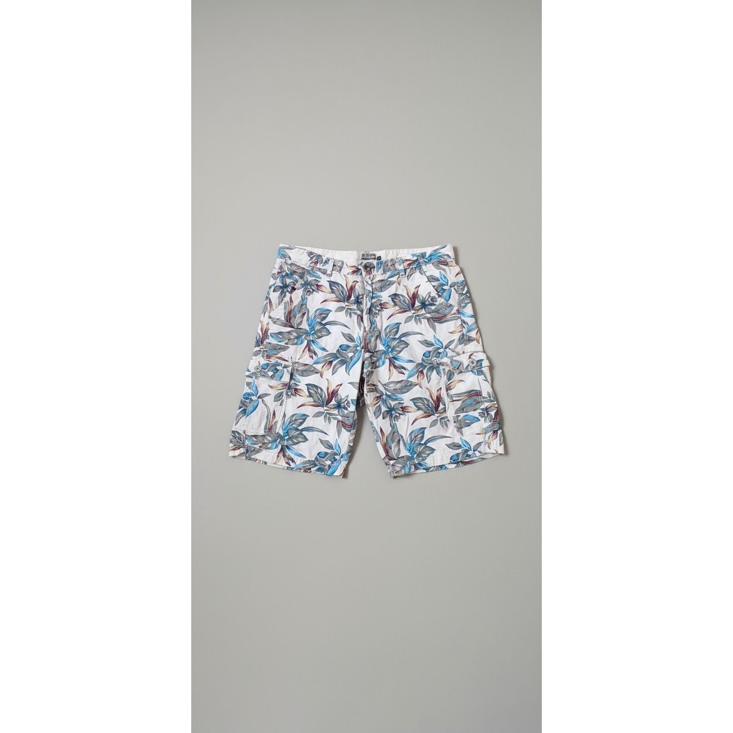 Floral-patterned pants on a hexagonal tiled floor with a dog and person's feet visible.