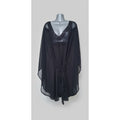 Black dress with embellishments on a wooden surface