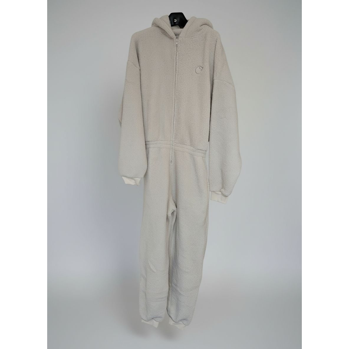 Light gray onesie on a dark background