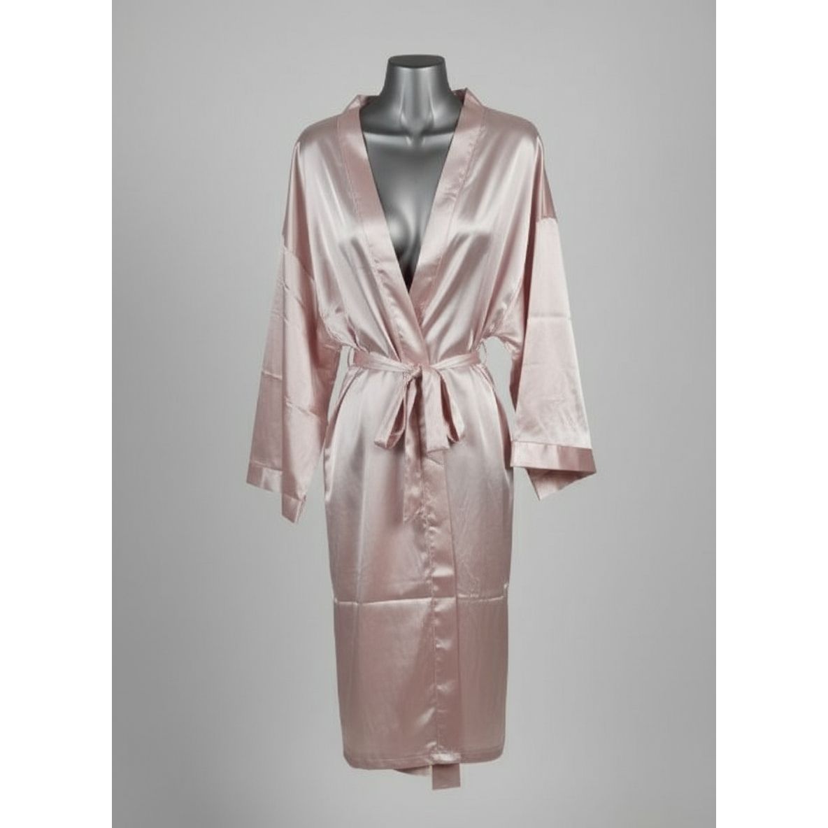 Pink satin robe on a mannequin against a neutral wall.