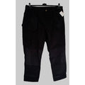 Black pants hanging against a white background