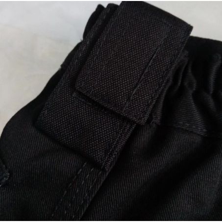 Close-up of a black fabric with a velcro strap on a white background