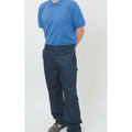 Person wearing a blue polo shirt and navy pants on a white background