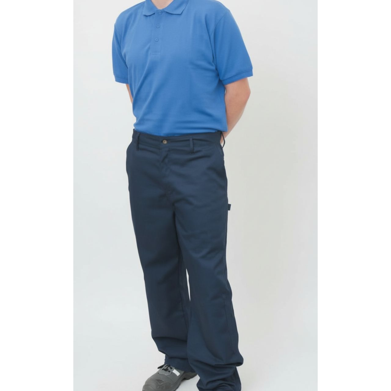 Person wearing a blue polo shirt and navy pants on a white background