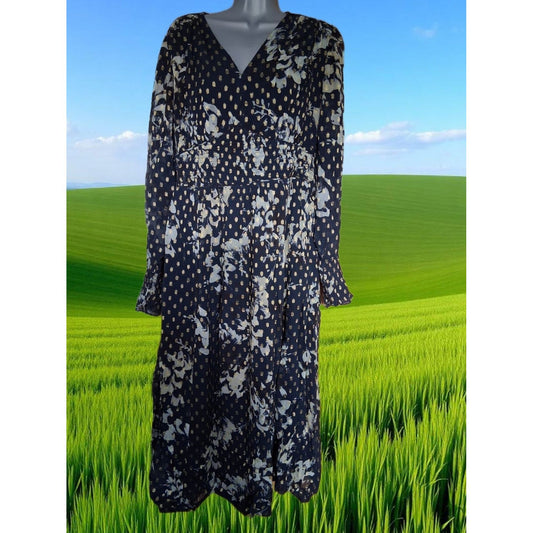 Navy floral dress on a mannequin against a green field and blue sky background