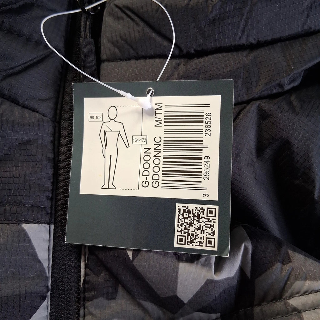 Clothing tag with barcode and QR code on a dark fabric background