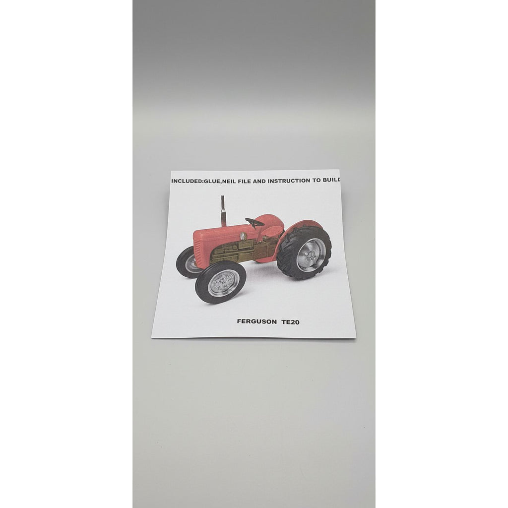 Instruction manual for a model tractor on a textured surface