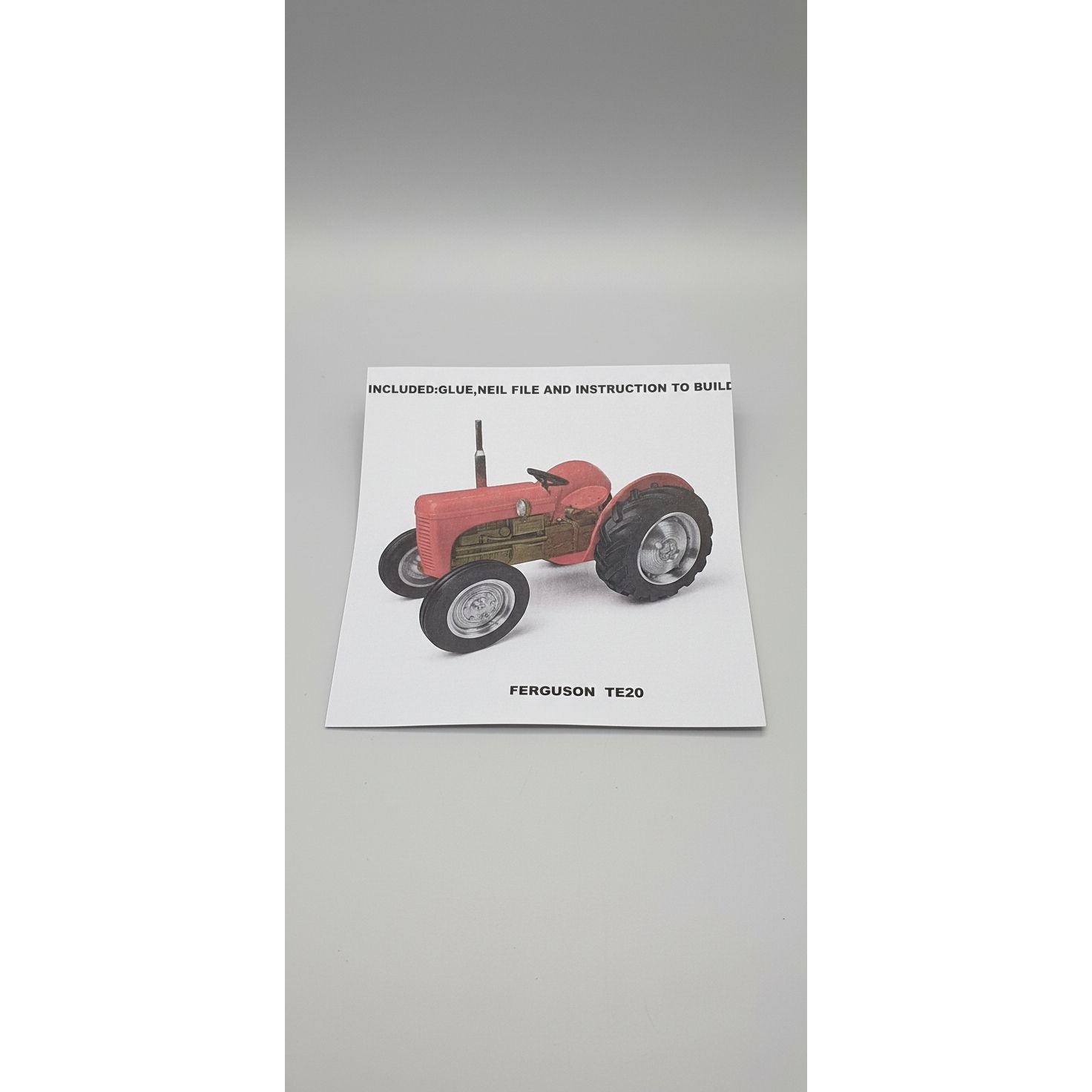 Instruction manual for a model tractor on a textured surface